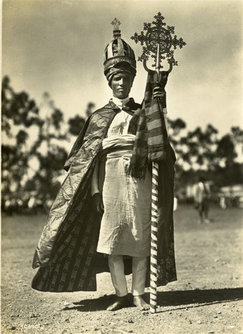Ethiopian Priest Dressed In Decorated Robes Headpiece And Staff The