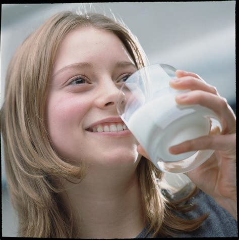 teenage girl drinking a glass of milk photograph by damien lovegrove fine art america