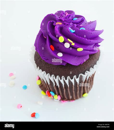 Chocolate Cupcake With Sprinkles And Purple Icing Stock Photo Alamy