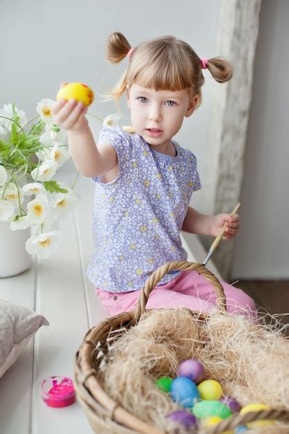 Premium Photo Little Girl Coloring Easter Eggs