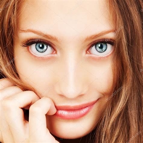 Portrait Of A Young Woman With Beautiful Hair And Blue Eyes Stock Photo