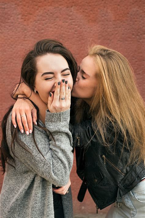 Blonde Girlfriend Kissing Brunette With Eyes Closed By Stocksy Contributor Danil Nevsky