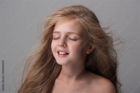Beautiful Mess Delighted Cute Little Girl Is Standing With Closed Eyes