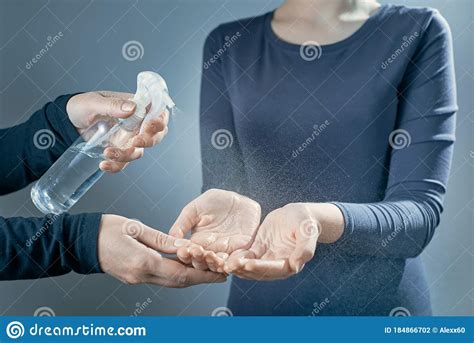 A Mother Treats Her Daughter`s Hands With Sanitizer Women`s Hands Are Treated With A Sanitizer