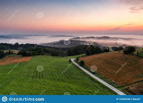Rolling Hills In Morning Fog At Sunrise In Coutryside In Poland Stock