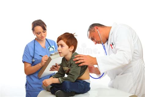 Médecin De Famille Avec Linfirmière Examinant Un Garçon Photo Stock