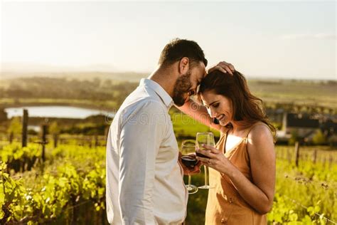 Couple In Love Standing In A Vineyard Holding Wine Stock Image Image