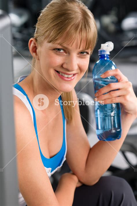 Smiling Woman Drink Water Relax At Weight Machine Fitness Center