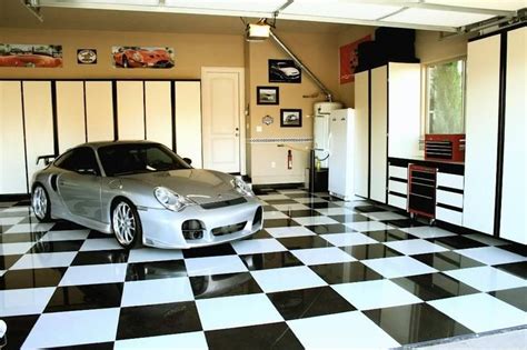 A Car Is Parked In A Garage With Black And White Checkerboard Flooring