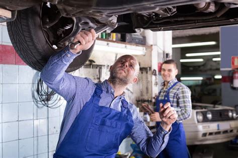 Two Mechanics In Car Fixing Workshop Stock Image Image Of Smiling