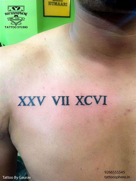 A Mans Chest With Roman Numerals Tattooed On The Upper Part Of His Chest