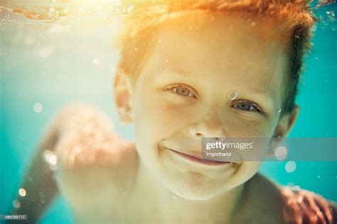 Closeup Portrait Of Little Boy Swimming Underwater In Pool High Res
