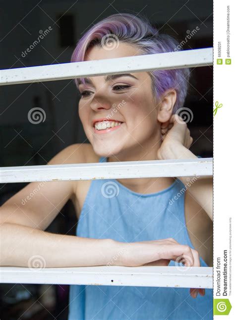 A Beautiful Violet Short Haired Woman Behind A Fence Stock Image Image Of Grid Girl 66908231