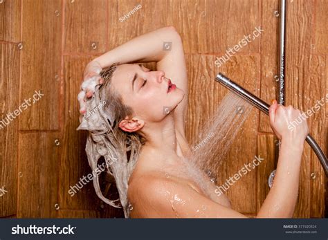 Beautiful Woman Standing Shower She Holds Stock Photo