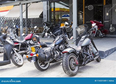 Motorcycles Parked On A Sidewalk With Graffiti In The Background In