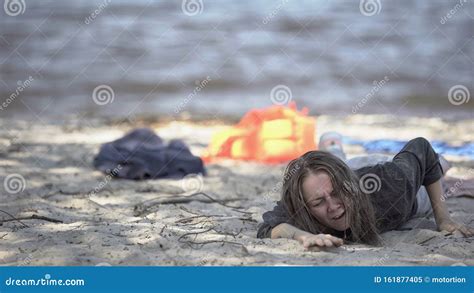 Miserable Woman Lying On Shore Feeling Unwell Shipwreck Refugee