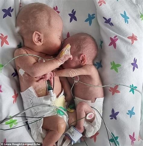 premature twins separated at birth cuddle and hold hands