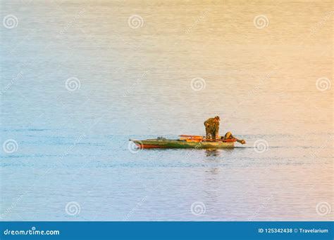 Alone Fisherman In Green Boat River Lake Landscape Stock Photo Image