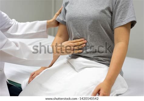 Female Doctors Examining By Abdominal Palpation Stock Photo 1420140542