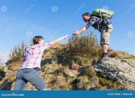 Man Helping His Girlfriend Hiking Stock Photo Image Of Backpack