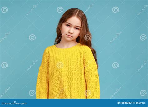 Portrait Of Unhappy Little Girl Looking At Camera With Sad Upset