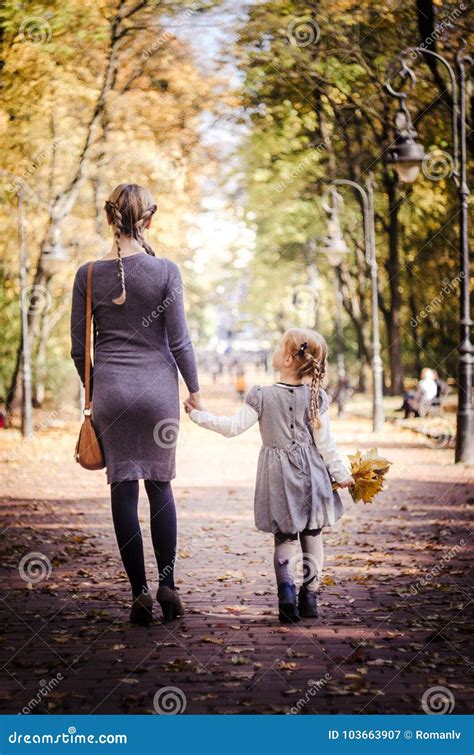 Mother With Daughter Walking In The Park In Autumn Holding Hands Stock Image Image Of Outdoor