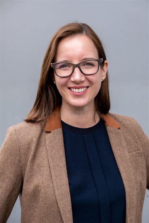 Portrait Of Smiling Brunette Woman In Suit With Glasses Stock Image