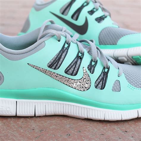 The Nike Free 5 0 Running Shoe Is Mint Green And Has Silver Accents On It