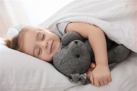 Cute Little Girl Sleeping With Toy Bunny Bedtime Schedule Stock Photo