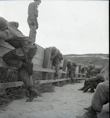 Trainees Climbing Over A Wall At Fort Ord — Calisphere