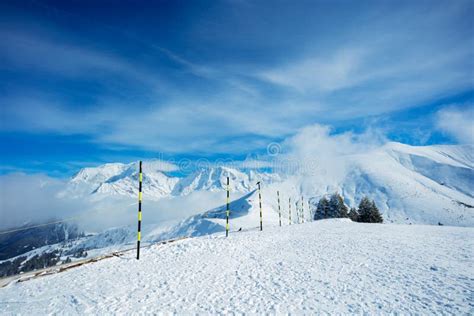 Ski Track Start On Top Of A Mountain Over Summits In Clouds Stock Image