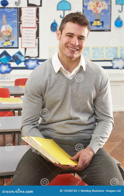 Male Teacher Sitting At Desk In Classroom Stock Image Image Of Study