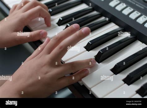 Fingers Of A Child On The Piano Keyboard Diagonal Position Stock Photo
