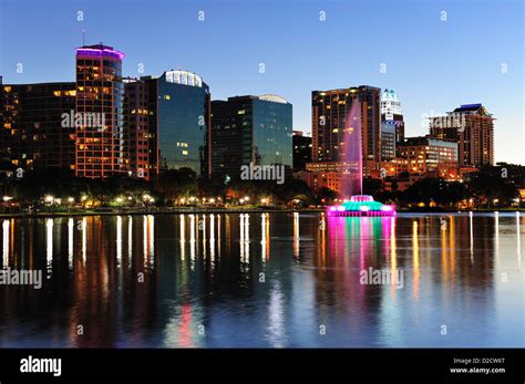 Orlando Downtown Skyline Panorama Over Lake Eola At Dusk With Urban