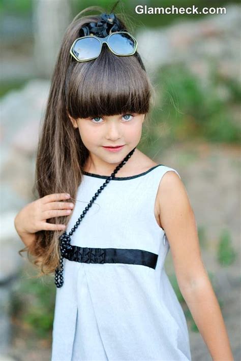 It keeps their hair neat, as well as, reduces the knots and tangles that they may get while at school or from playing. Styling Ideas for Little Girls with Long Hair and Bangs