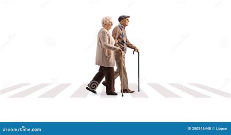 Full Length Profile Shot Of An Elderly Couple Walking At Pedestrian