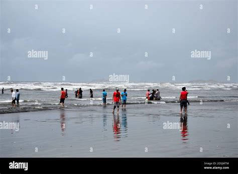 People And Families Wade In Water And Enjoy The Waves At Sea View Beach