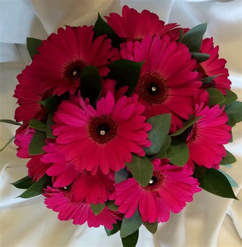 Diy centerpieces with bright flowers in glass bud vases. Gerbera as bridal bouquet with diamanté detail gerber ...