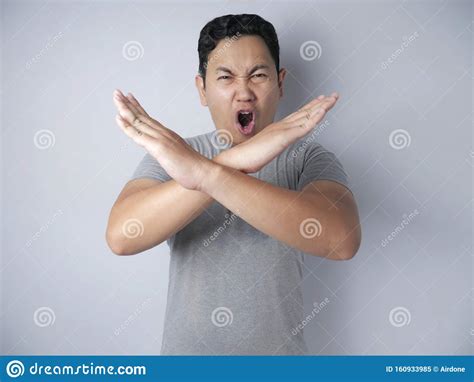 Angry Young Man Shows Stop Sign Crossed Arms Gesture Stock Image