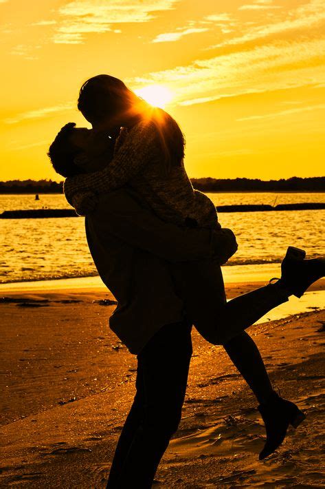 Engaged Couple Kiss At Golden Sunset On The Beach Couple Beach Photos Kissing Couples