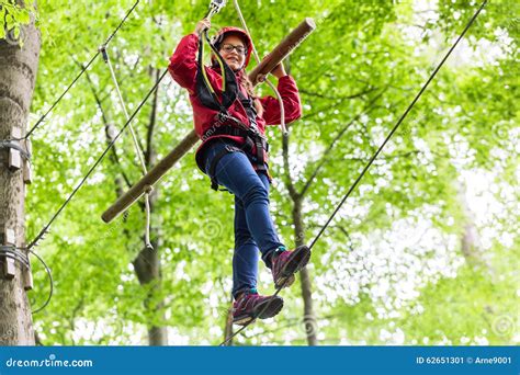 Child Reaching Platform Climbing In High Rope Course Stock Image