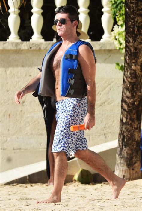 simon cowell relaxes on holiday in barbados and enjoys a ride on a jet ski celebrity news