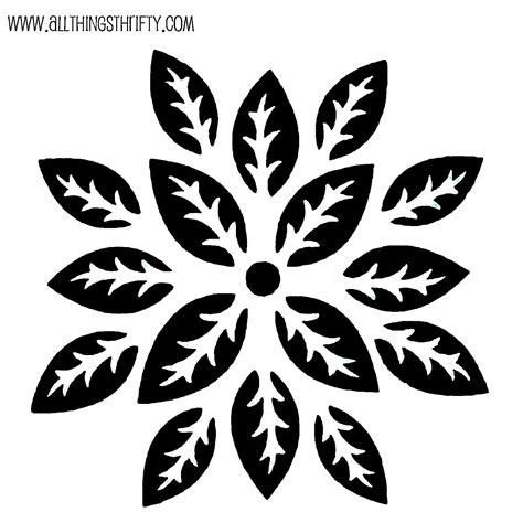 A Black And White Snowflake With Leaves On It
