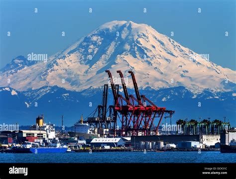 Seattle Port With Red Cranes Ships And Mt Rainier In The Background