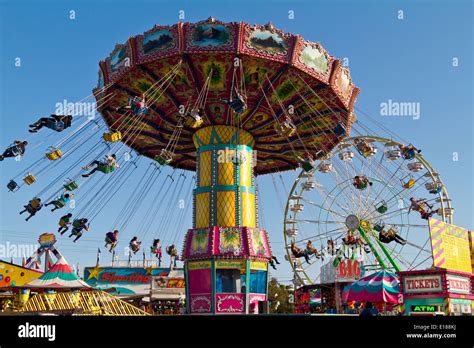 People Spinning In Air Hanging In Chairs On A Carnival Ride Stock Photo
