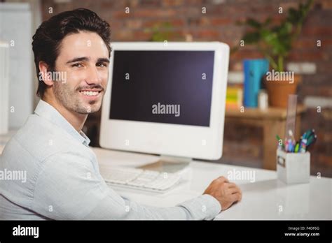 Handsome Man Sitting At Office Desk Stock Photo Alamy