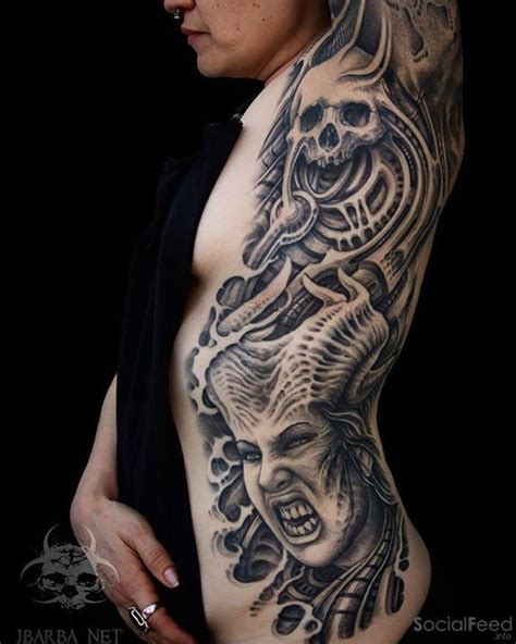 creepy looking black ink side and arm tattoo of demonic woman with skull tattooimages