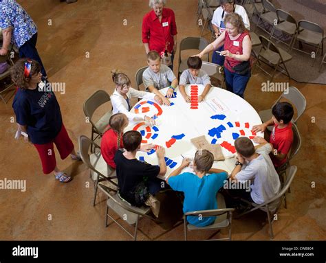 Children Play Card Game On A Round Table At A Week Long Vacation
