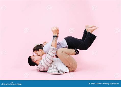 Adorable Couple Kissing In A Gymnastic Position Guy Holding Girl On