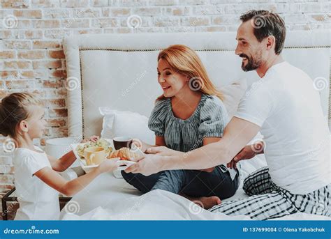 Happy Girl Bringing Breakfast To Parents In Bed Stock Photo Image Of